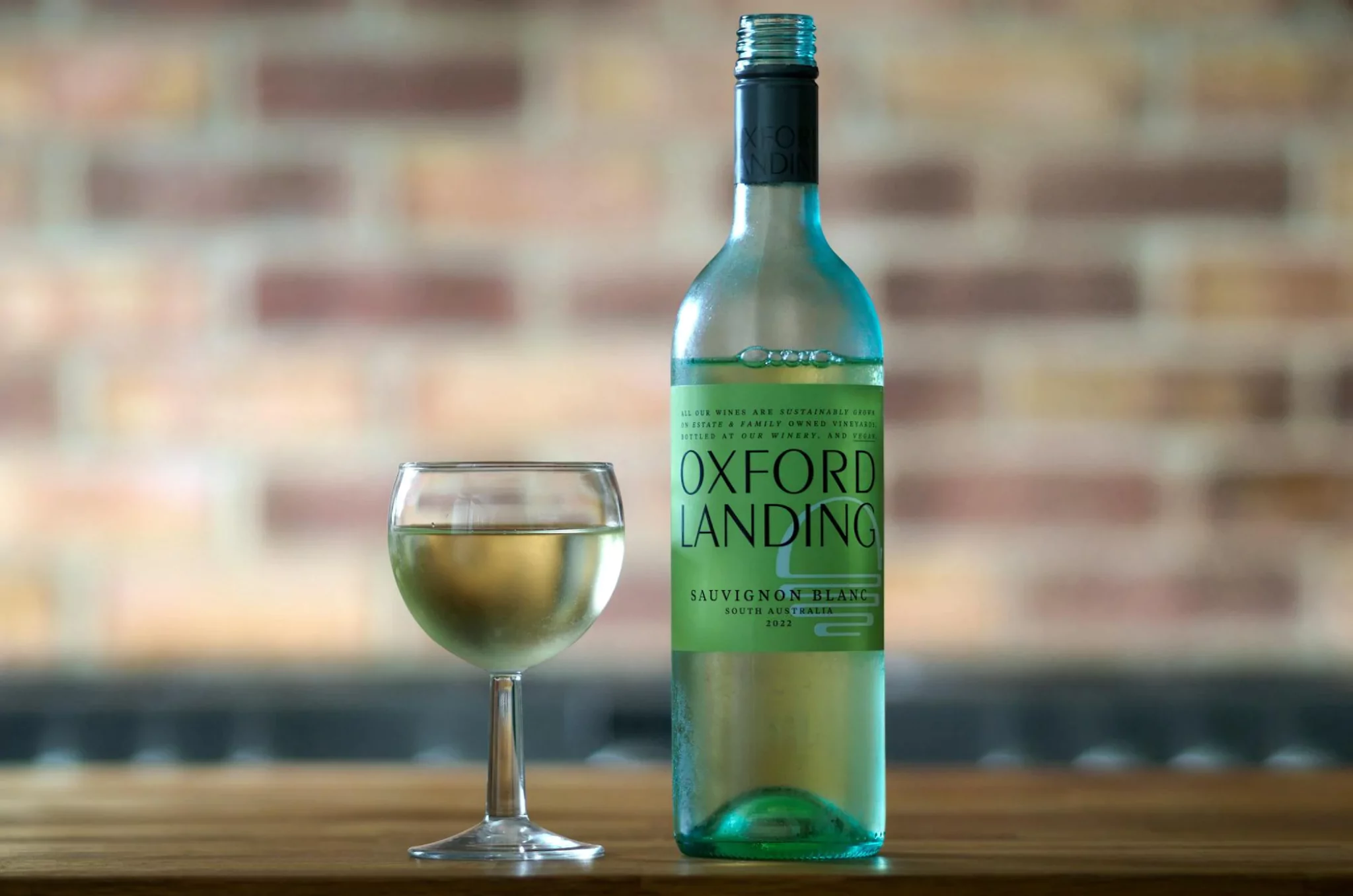 Wine bottle next to filled glasses showing wine serving sizes and standard pours.