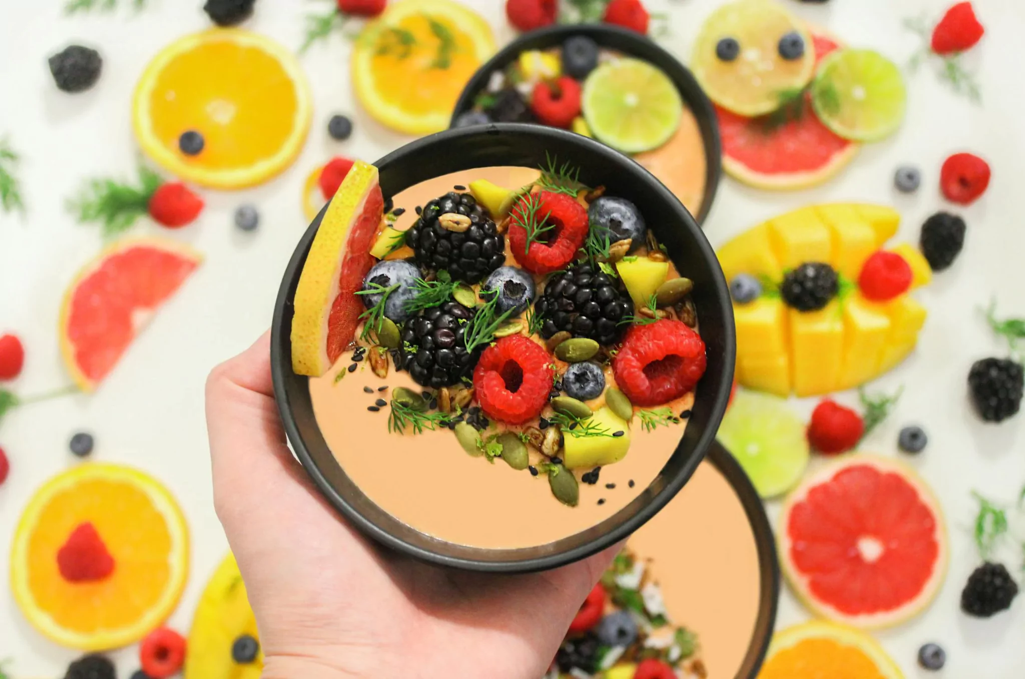 Top view of anti-inflammatory diet foods including salmon, berries, leafy greens, turmeric, olive oil, nuts, and green tea on a wooden table.